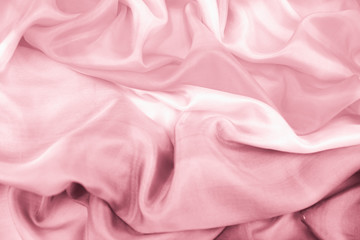 The texture of the satin fabric of pink color for the background 