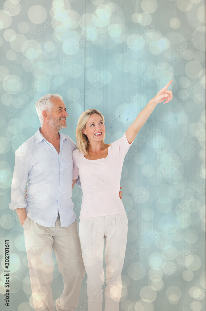 Poster smiling couple walking and pointing against light glowing dots design pattern