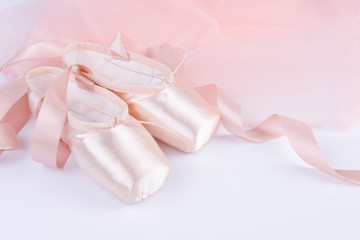 Obraz na płótnie Canvas Closeup of ballet shoes with pink ballet costume