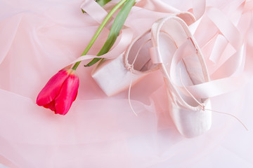 Top view of ballet shoes and tulips 