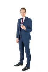 Businessman holding his smartphone and looking at camera 