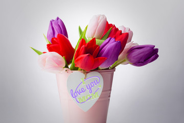 mothers day greeting against tulips with note