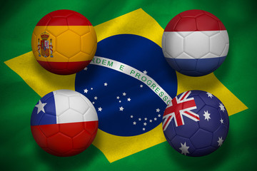 Composite image of group b footballs for world cup against digitally generated brazilian national flag