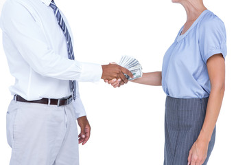 Businessman giving bank notes to his colleague