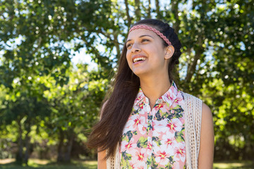 Pretty hipster smiling in the park