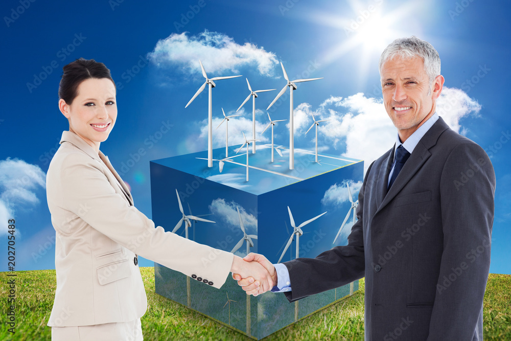 Aufkleber smiling business people shaking hands while looking at the camera against wind turbines on cube show
