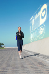 Fit blonde jogging on the pier against fitness interface