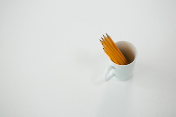 Yellow color pencils kept in mug