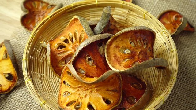 Rotating slices of dry bael fruit in basket, close-up, 4K