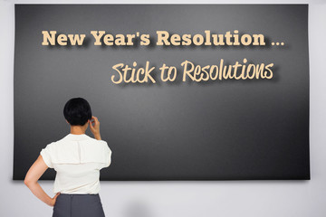 Thoughtful businesswoman against black chalkboard