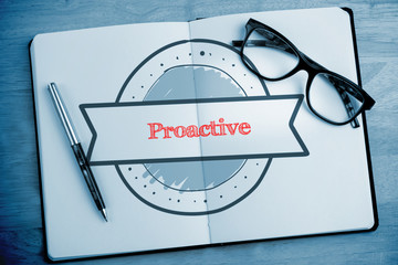 The word proactive and banner drawing against overhead of open notebook with pen and glasses