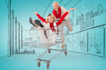 Happy festive couple messing in trolley against blue vignette