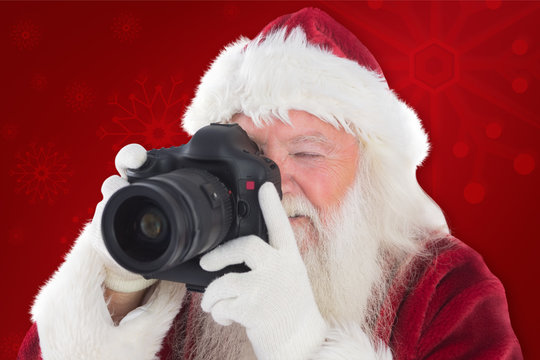 Santa is taking a picture against red background
