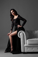 Fototapeta na wymiar Young elegant woman in long black dress.
