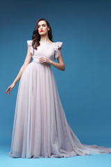 Fototapeta na wymiar Young elegant woman in long pink dress.