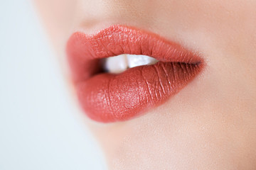 Fototapeta premium Professional makeup. Lipgloss. Close up portrait of beautiful girl with colorful red lips and lipstick. Caucasian young woman model with bright makeup