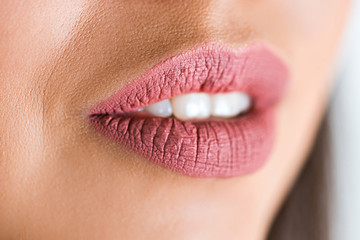 Close up of sexy open lips of woman on white background. Pink lipstick, lip gloss on the lips.