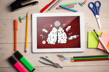 Composite image of digital tablet on students desk showing doodles