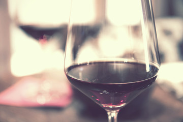 glass of red wine vintage effect, closeup of alcoholic beverage
