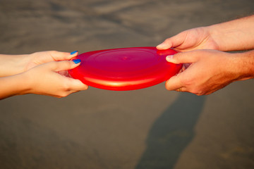 Frisbee in hands on the beach