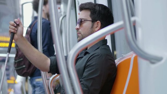 independence, handicap- young blind man travels alone by metro