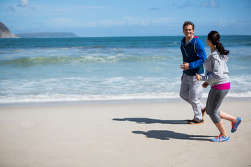 Mature couple jogging on beach