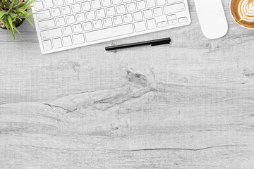 Wood office desk table with computer gadgets, cup of coffee and supplies. Top view with copy space,...