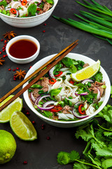 Vietnamese Beef Noodle Soup Pho Bo with beef on dark background - 202722251