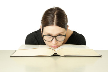 Studio portrait of young woman in front of big book on the table, don't feel like studying concept