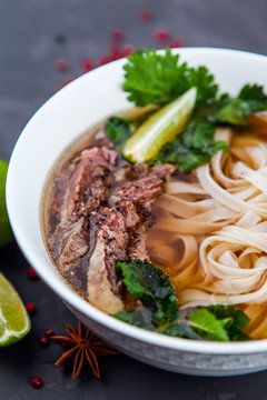 Vietnamese Pho Noodle Soup. Beef with Chilli, Basil, Rice Noodles, Bean Shoots showing noodles