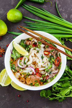 Vietnamese Beef Noodle Soup Pho Bo with beef on dark background
