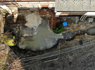 Aerial view with vertical angle of view of an excavation pit filled with liquid soil