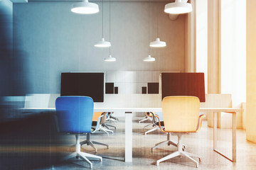 Orange and blue chairs office close up blur