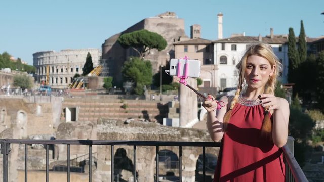 Funny pretty young woman taking selfie in Rome