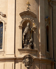 Fototapeta na wymiar PRAGUE, CZECH REPUBLIC - MAY 16, 2017: Religious sculptures on the exterior of a church in the centre of Prague.
