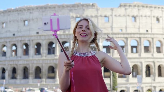 Happy and smiling tourist taking selfie in Rome
