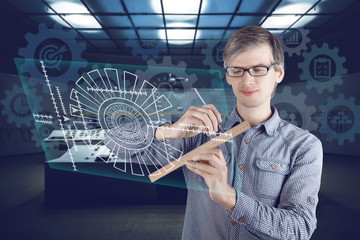 Virtual reality in engineering concept. Male / man wearing shirt and glasses making measurements with ruler and pencil and constructing turbine on the virtual screen on futuristic background