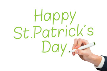 Hand writing with blue marker against happy st patricks day