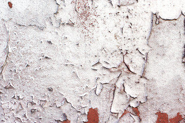 Shabby orange wall covered with silvery paint.