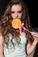 woman eats sweet candy lollipop