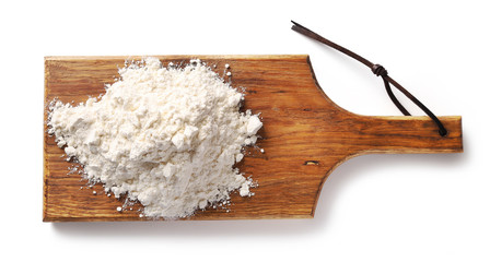 heap of flour on wooden cutting board