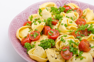 Filled tortellini with herbs, tomatoes