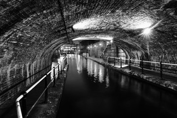 Tunnel in the city center during the rain at night, famous Birmingham canal in UK. Black and white