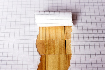 Paper tear on cube wood background