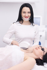 Young girls. Laser hair removal. Cosmetic procedure. Modern equipment