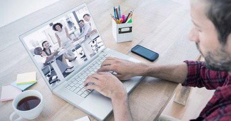 Obraz na płótnie Canvas Creative businessman typing on laptop against female business woman giving a presentation 