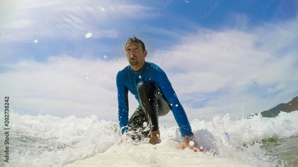 Canvas Prints Surfer riding a wave on a white surfboard