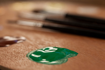 Wooden palette with multiple colors and paint brushes