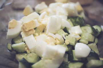 background of sliced boiled eggs and fresh cucumbers