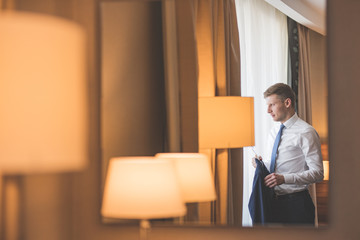 Young groom by the window